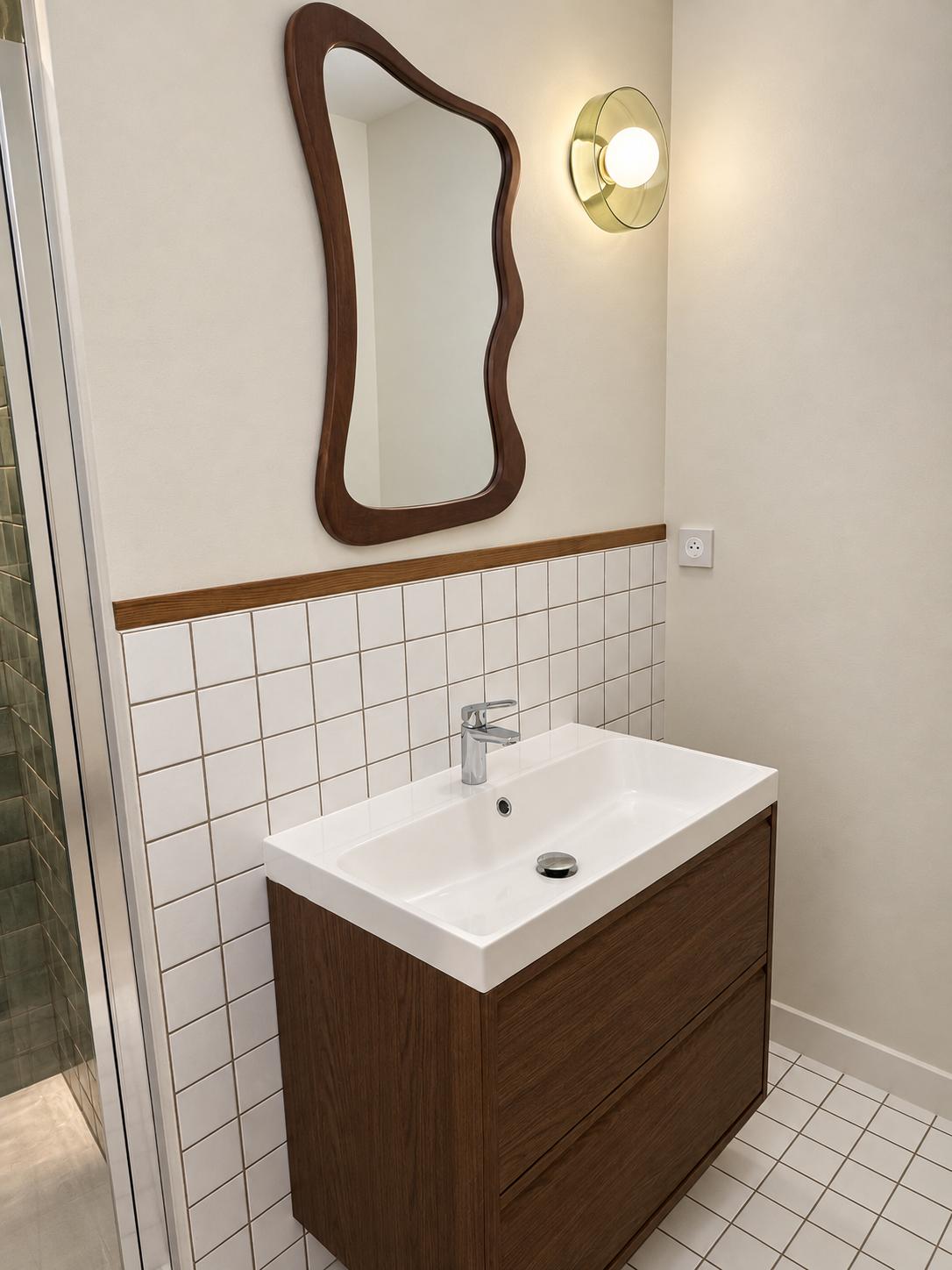Vasque et miroir aux lignes arrondies dans la salle de bain rénovée